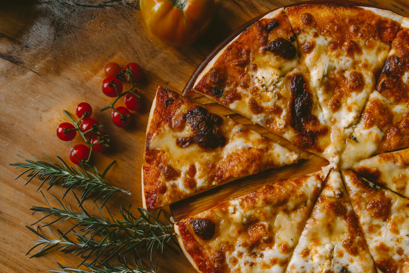 A perfectly charred, golden-crusted Gourmet Trails pizza fresh from the oven